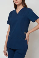 Pocket, neckline and seam details on the Matte Blue Avison Scrub Top