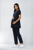 Model wearing Dark Navy NF30 Maternity Scrub Top by Good Uniform, full side view