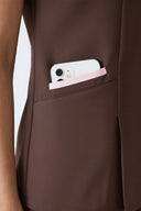 Pocket details on the Brown Anyone Zip Scrub Top