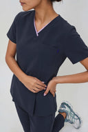 Pocket, neckline and seam details on the Dark Navy Anyone Zip Scrub Top