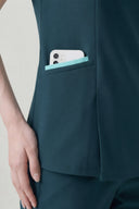 Pocket and seam details on the Antique Blue Anyone Zip Scrub Top