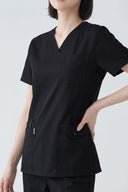 Pocket, neckline and seam details on the Black Avison Scrub Top