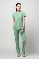 Model wearing Smoke Mint CST202 Scrub Top by Good Uniform, full front view