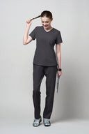 Grey CST203 Scrub Top shown during movement to demonstrate fit and flexibility, full shot