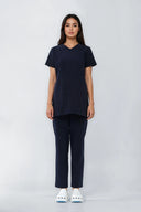 Model wearing Dark Navy NF30 Maternity Scrub Top by Good Uniform, full front view