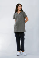 Model wearing Mild Grey NF30 Maternity Scrub Top by Good Uniform, full front view