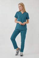 Model wearing Aquamarine ST215 Scrub Top by Good Uniform, full front view