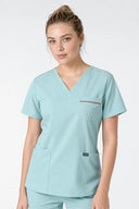 Model wearing Mint Haze ST247 Scrub Top in a studio setting, three-quarter view