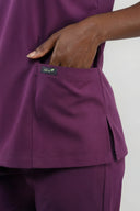 Pocket details on the Plum Purple ST247 Scrub Top from the side