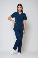 Model wearing Matte Blue Avison Scrub Top by Good Uniform, full front view