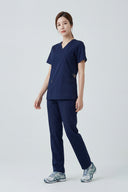 Modern Navy Avison Scrub Top shown during movement to demonstrate fit and flexibility in full view