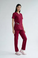 Rosé Wine Avison Scrub Top shown in full view during movement to demonstrate fit and flexibility