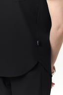 Side detail of the Jet Black CST201 Scrub Top by Good Uniform