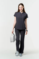 Grey CST202 Scrub Top shown during movement to demonstrate fit and flexibility in full view