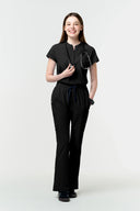 Jet Black CST202 Scrub Top shown during movement to demonstrate fit and flexibility in full view from front
