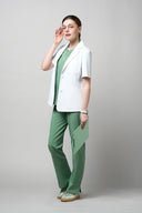 Model wearing Smoke Mint CST203 Scrub Top and short-sleeve medical jacket by Good Uniform, full front-side view