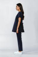 Model wearing Dark Navy NF30 Maternity Scrub Top by Good Uniform, full side view