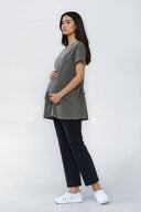 Model wearing Mild Grey NF30 Maternity Scrub Top by Good Uniform, full side view