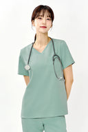 Model wearing Tiffany Mint ST002 Scrub Top in a studio setting, three-quarter view