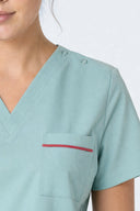 Pocket, neckline and seam details on the Mint Haze ST247 Scrub Top