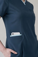 Pocket, neckline and seam details on the Antique Blue Anyone Zip Scrub Top