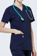 Pocket, neckline and seam details on the Modern Navy Avison Scrub Top with stethoscope around neck
