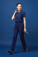 Warm Navy CST201 Scrub Top shown during movement to demonstrate fit and flexibility in full shot