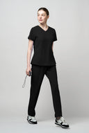 Jet Black CST203 Scrub Top shown during movement to demonstrate fit and flexibility