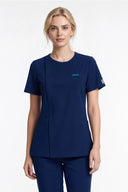Model wearing Indigo Blue Mild280 Zip Scrub Top in a studio setting, three-quarter view