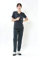 Model wearing Charcoal ST002 Scrub Top by Good Uniform, full front view