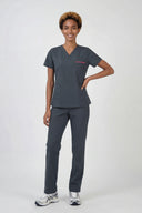 Model wearing Deep Slate ST247 Scrub Top by Good Uniform, full front view