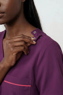 Pocket, neckline and shoulder details on the Plum Purple ST247 Scrub Top