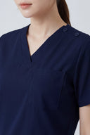 Pocket, neckline and seam details on the Modern Navy Avison Scrub Top