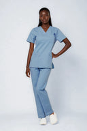 Model wearing Soft Blue Avison Scrub Top by Good Uniform, full front view