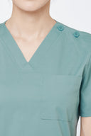 Pocket, neckline and seam details on the Vintage Mint Avison Scrub Top