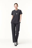 Model wearing Grey CST201 Scrub Top by Good Uniform, full front view