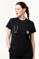 Model wearing Jet Black CST201 Scrub Top in a studio setting, three-quarter view