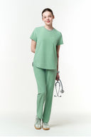 Model wearing Smoke Mint CST201 Scrub Top by Good Uniform, full front view in the studio