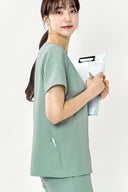 Side fit of the Tiffany Mint ST002 Scrub Top by Good Uniform showing pen sleeve detail