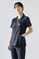 Model wearing Navy ST215 Scrub Top in a studio setting, three-quarter view slightly form the side