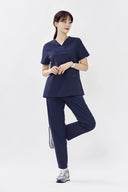 Model wearing Royal Purple ST215 Scrub Top by Good Uniform, full front view