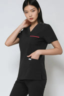 Pocket details on the Black ST247 Scrub Top with hand in the pocket