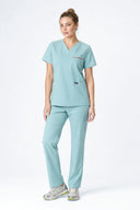 Model wearing Mint Haze ST247 Scrub Top by Good Uniform, full front view