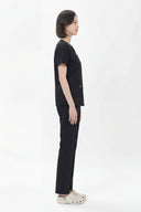 Side fit of the Black Avison Scrub Top by Good Uniform in full side view