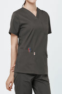 Pocket, neckline and seam details on the Burnt Brown Avison Scrub Top showing practicality of the pockets