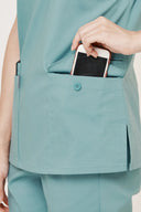Model showing pocket, functionality on the Vintage Mint Avison Scrub Top