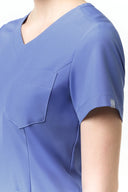 Pocket, neckline and seam details on the Lavender Blue CST203 Scrub Top from the side