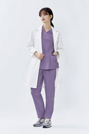 Model wearing Lavandula ST215 Scrub Top and lab coat by Good Uniform, full front view