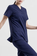 Royal Purple ST215 Scrub Top shown during movement to demonstrate fit and flexibility