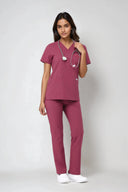 Model wearing Dusty Rose ST247 Scrub Top by Good Uniform, full front view